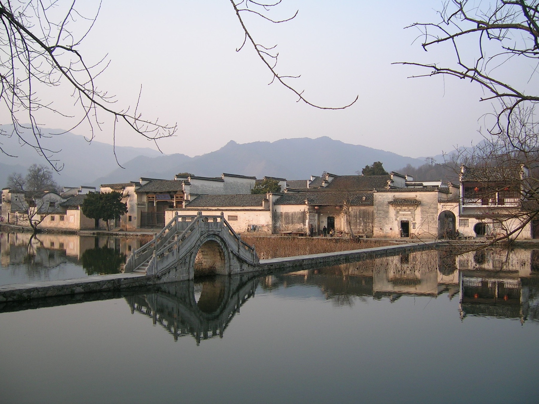 White-walled houses reflected in the pond at Hongcun village