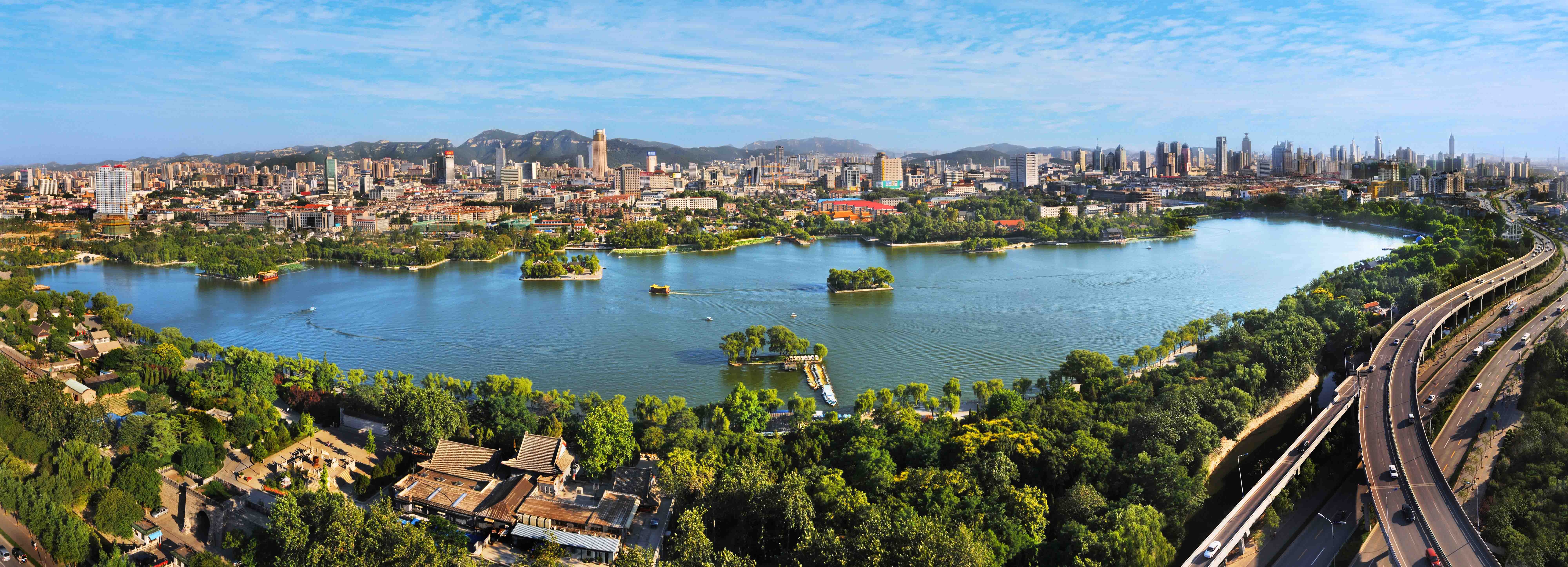 Wide panoramic view across Daming Lake and the Jinan skyline