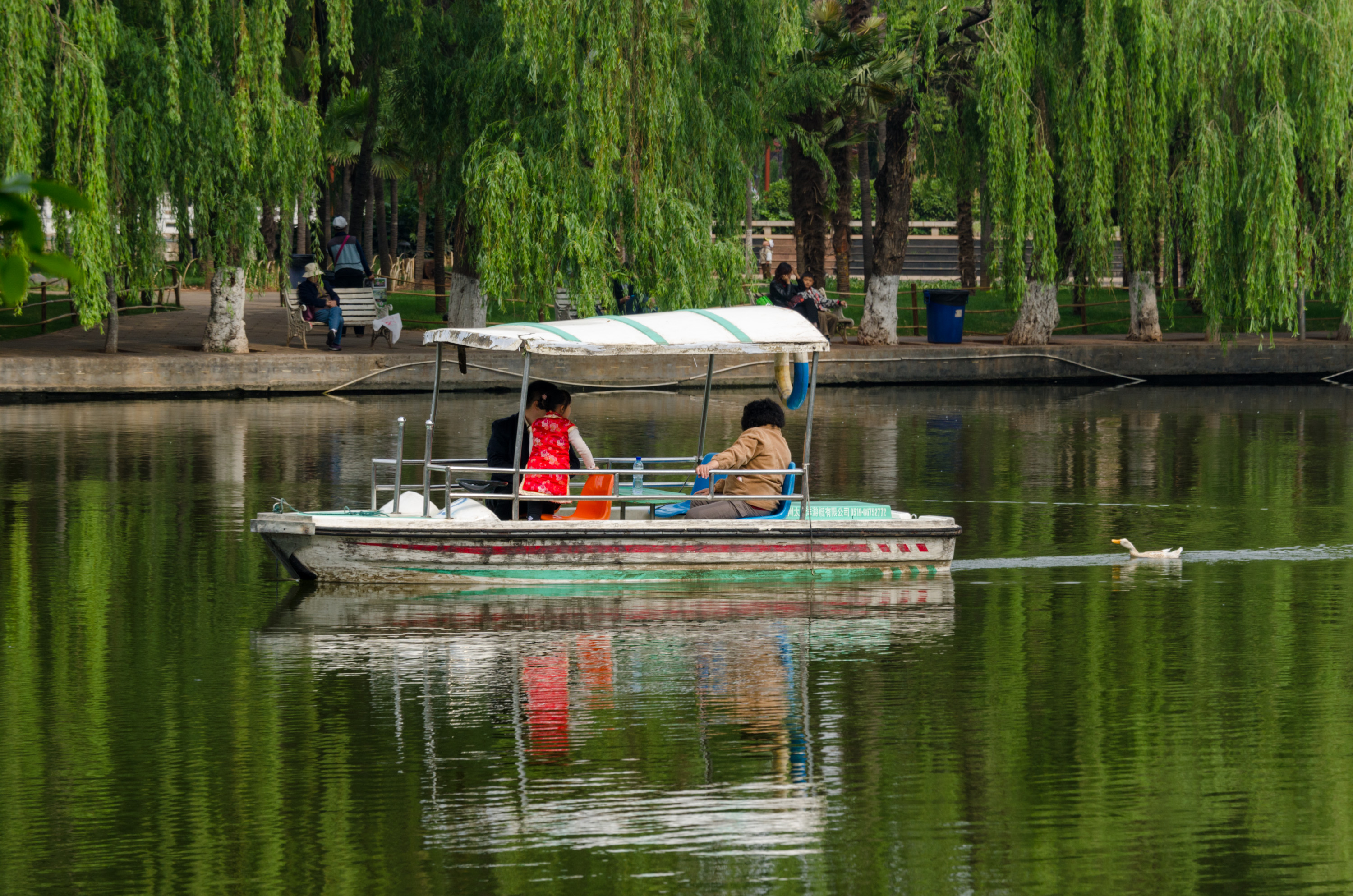 Pavilions and leafy paths reflected in Green Lake Park in Kunming