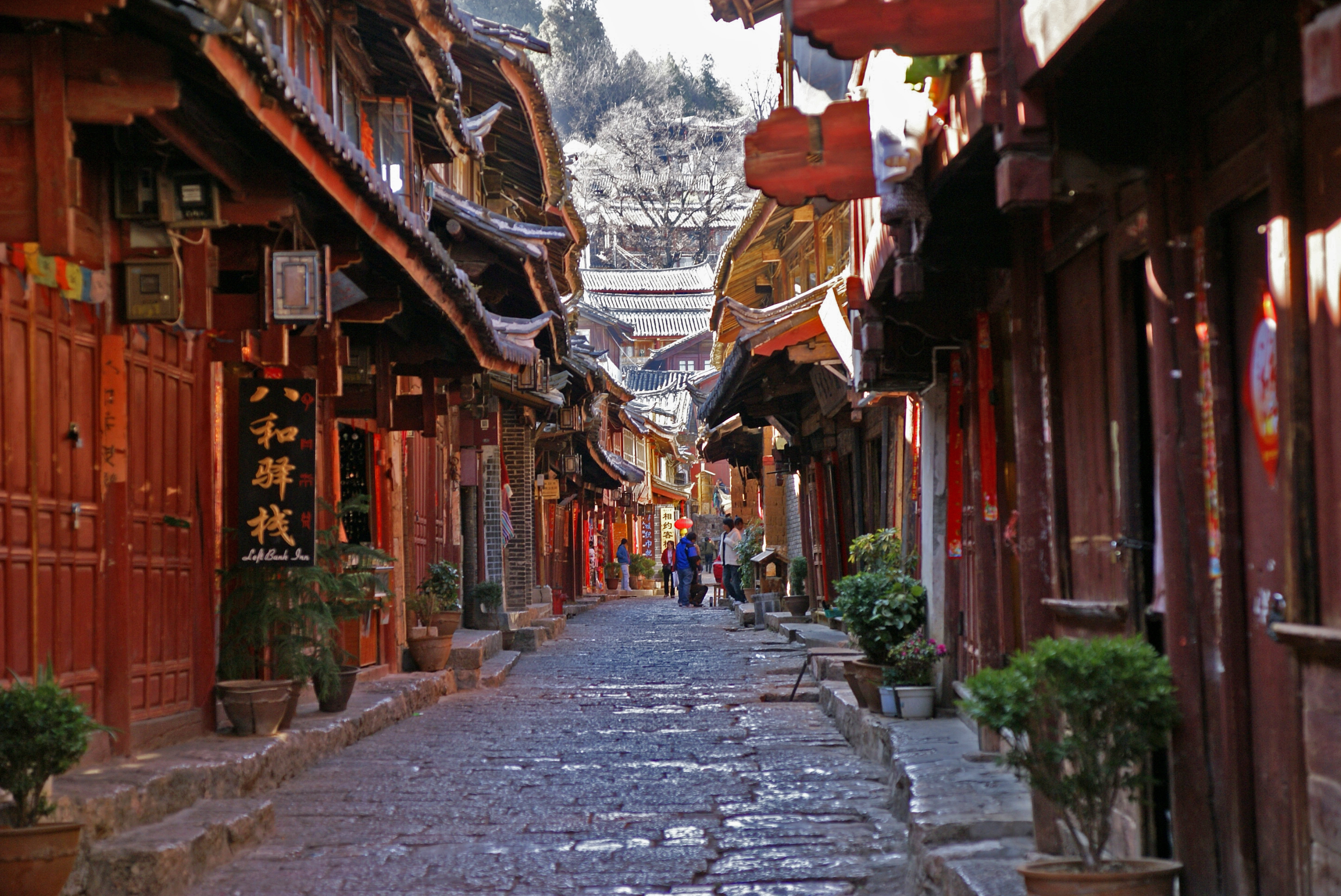 Stone pedestrian lane lined with traditional buildings in Lijiang Old Town