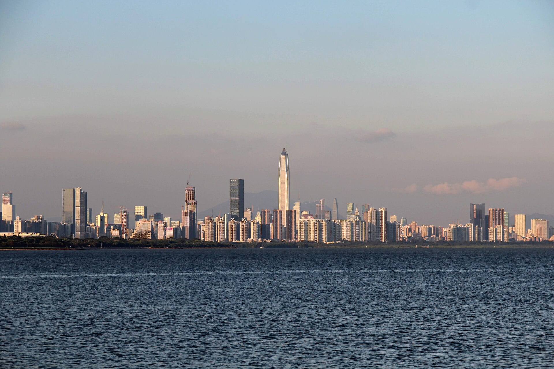 Futian skyline viewed across Shenzhen Bay near sunset
