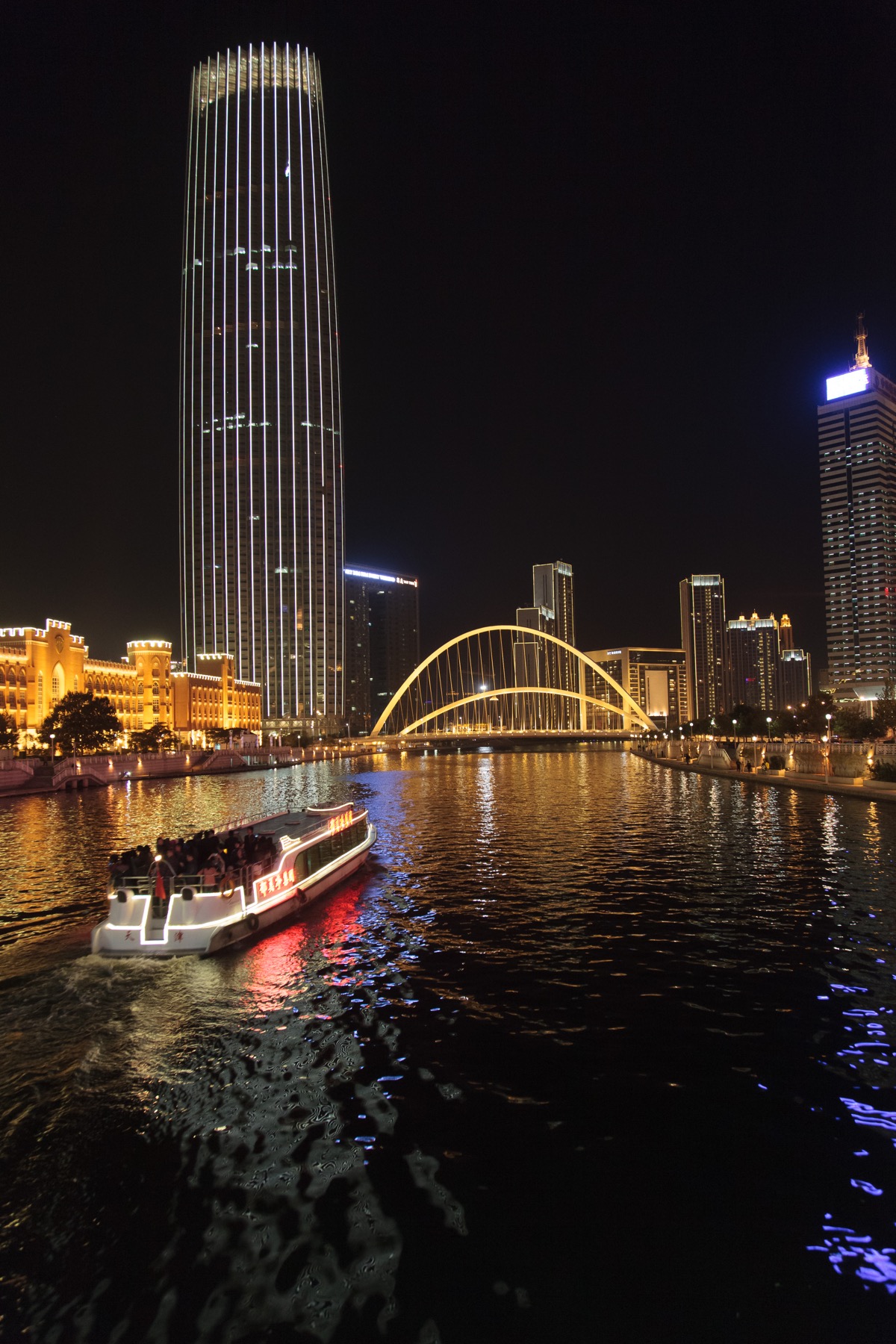 Tianjin skyline and illuminated buildings reflected in the Haihe River at night
